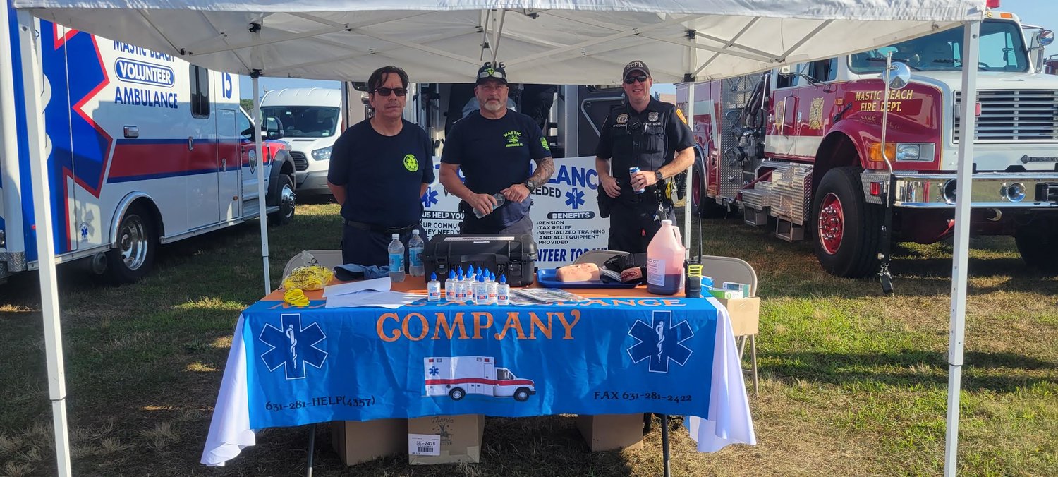 Walter Meshenberg, an EMT volunteer (left), George Rachun, an EMT driver (center), and Dennis O’Connor, a police paramedic (right), stand in the Mastic Ambulance tent.